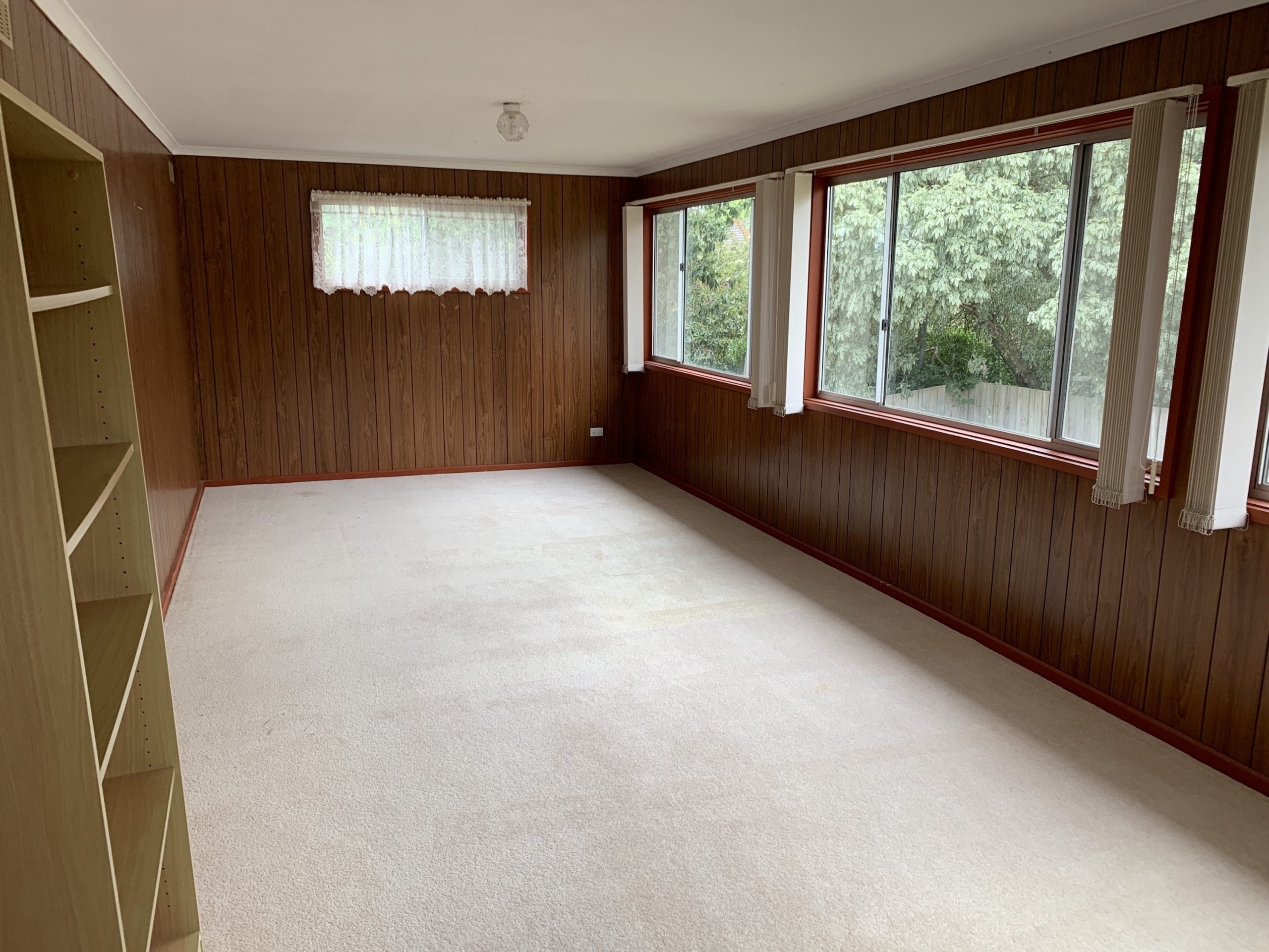 Large and empty living room well lit from windows
